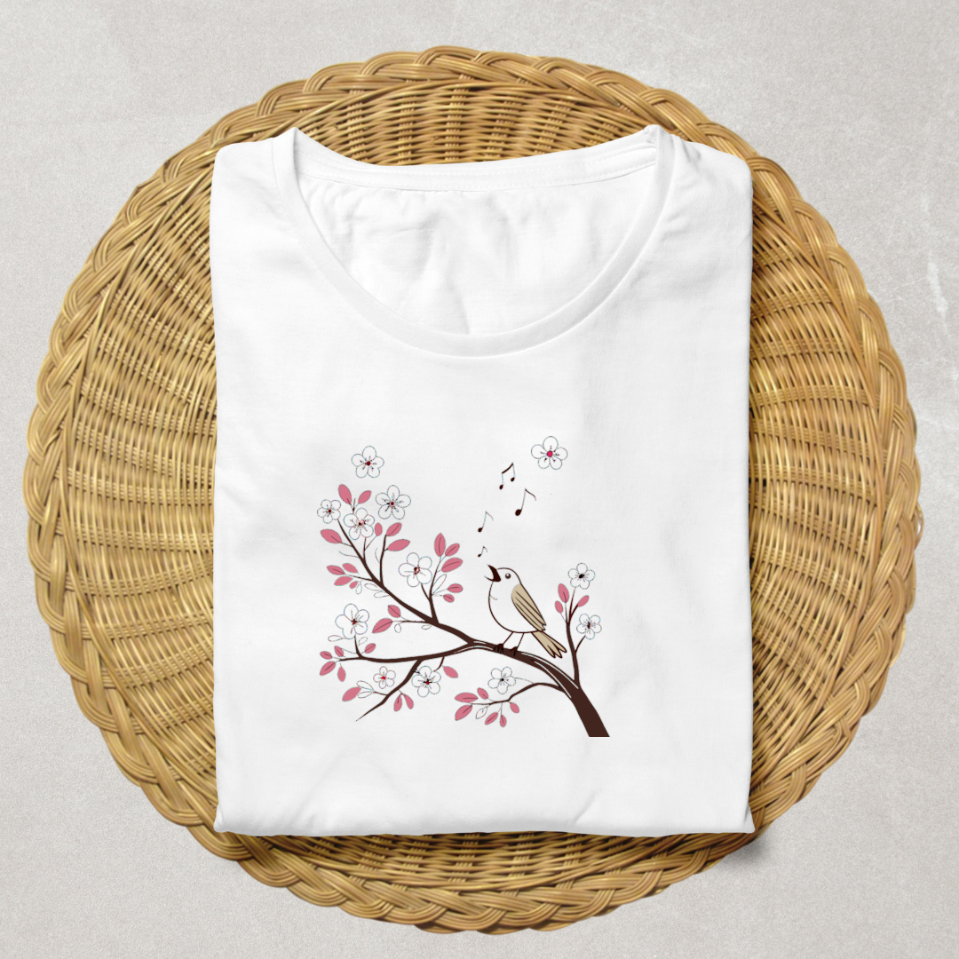 T-shirt décoré d'un oiseau pastel chantant sur une branche fleurie en style printanier