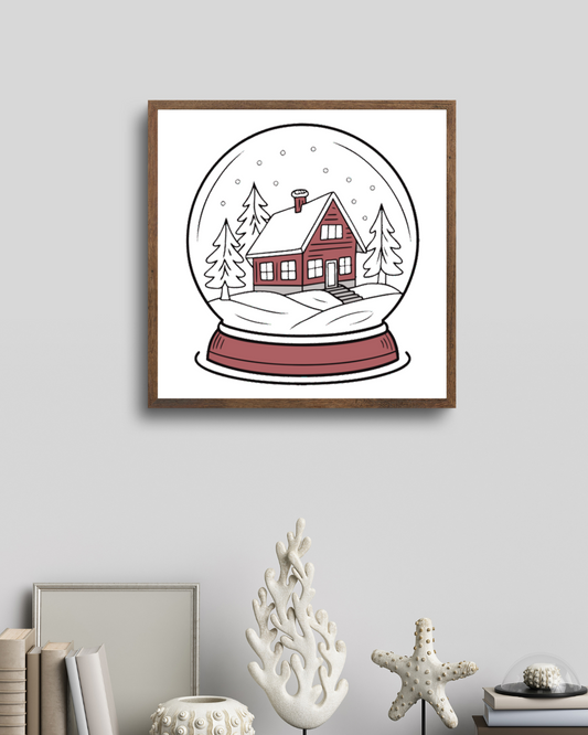 Cadre avec illustration hivernale représentant une maison enneigée dans une boule à neige