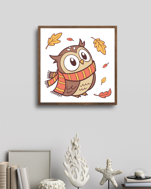 Cadre mettant en valeur une chouette en écharpe aux couleurs automnales avec feuilles