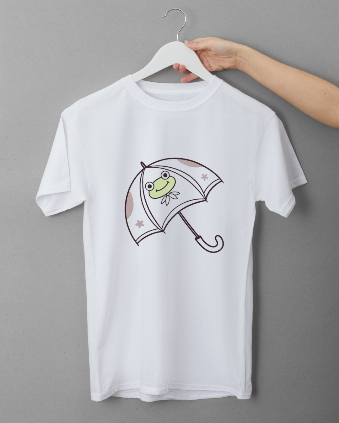 T-shirt avec une grenouille joyeuse sous un parapluie dans un style pastel joueur