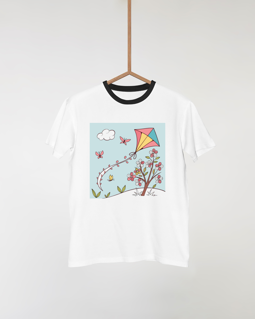 T-shirt avec cerf-volant minimaliste volant au-dessus de fleurs printanières