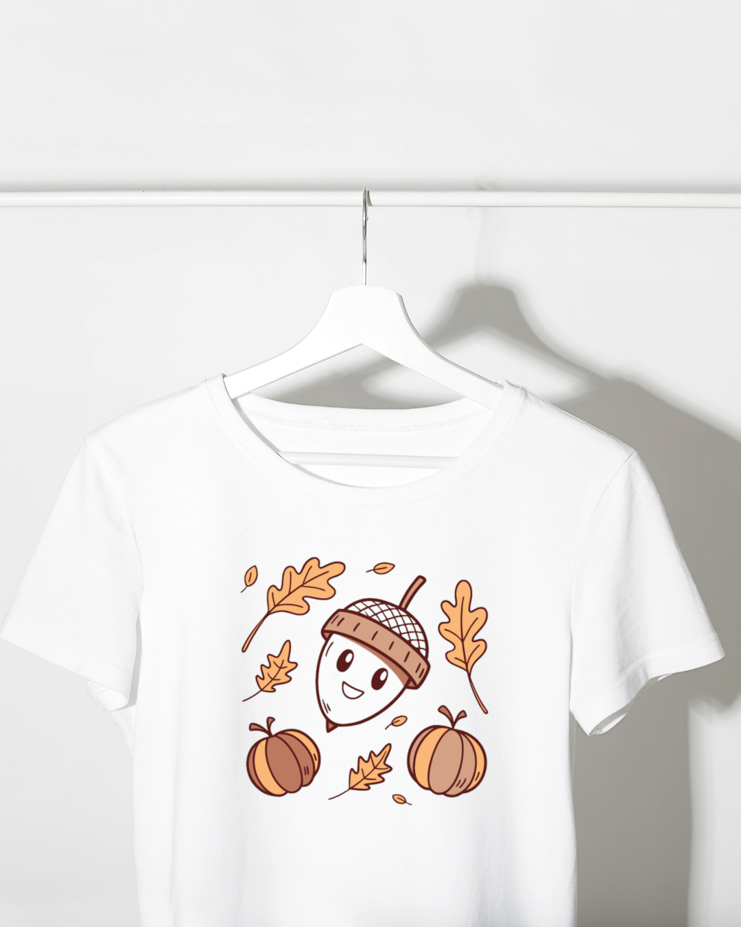 T-shirt illustré au doux motif pastel de gland souriant dans une ambiance automnale