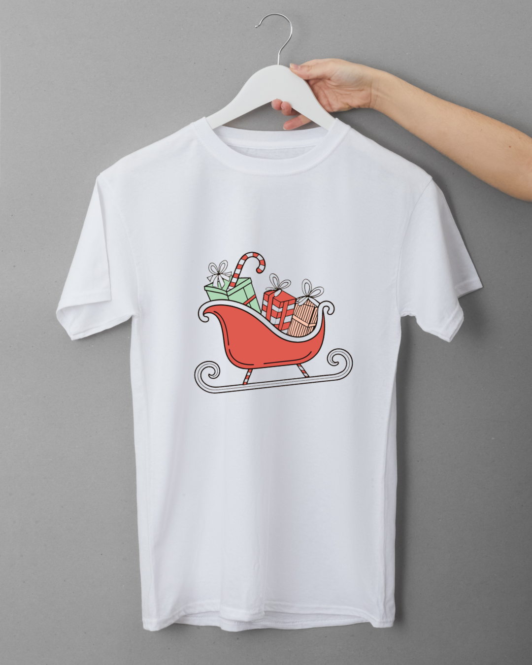 T-shirt avec design pastel montrant un traîneau rempli de cadeaux pour Noël