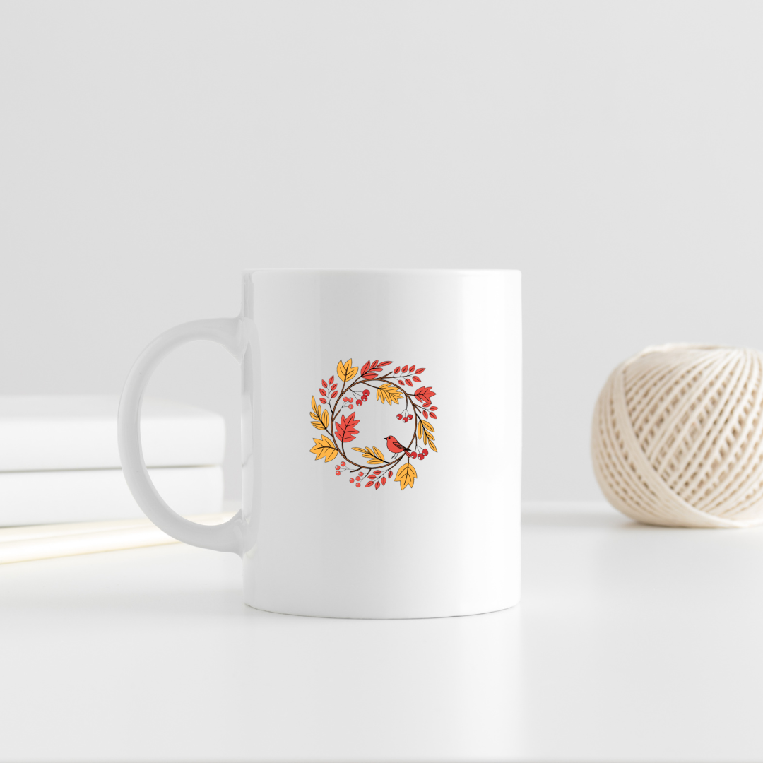 Mug décoré d'un oiseau entouré de feuillage automnal dans des tons pastel