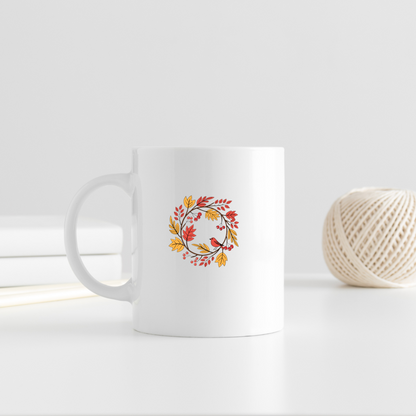 Mug décoré d'un oiseau entouré de feuillage automnal dans des tons pastel