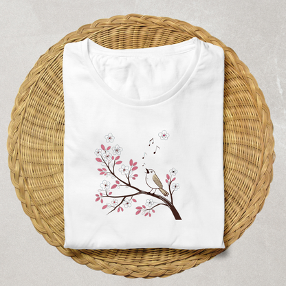 T-shirt décoré d'un oiseau pastel chantant sur une branche fleurie en style printanier