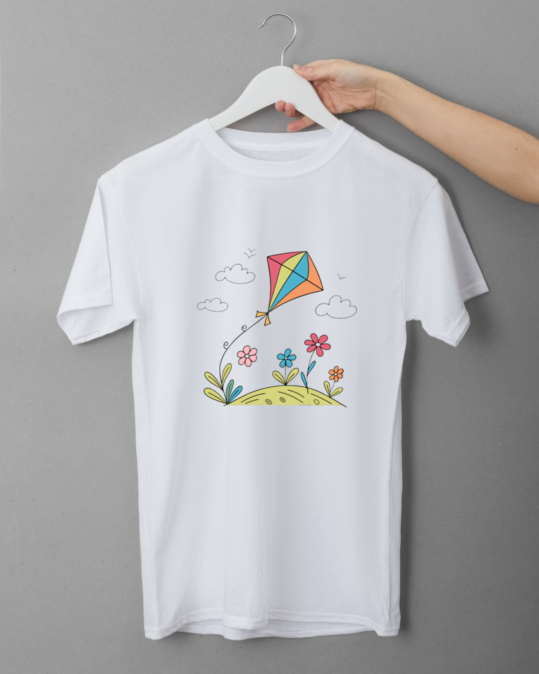T-shirt avec un cerf-volant coloré flottant sur fond de motifs floraux printaniers