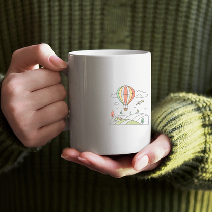 Mug avec montgolfière sur fond pastel offrant une touche aérienne et apaisante