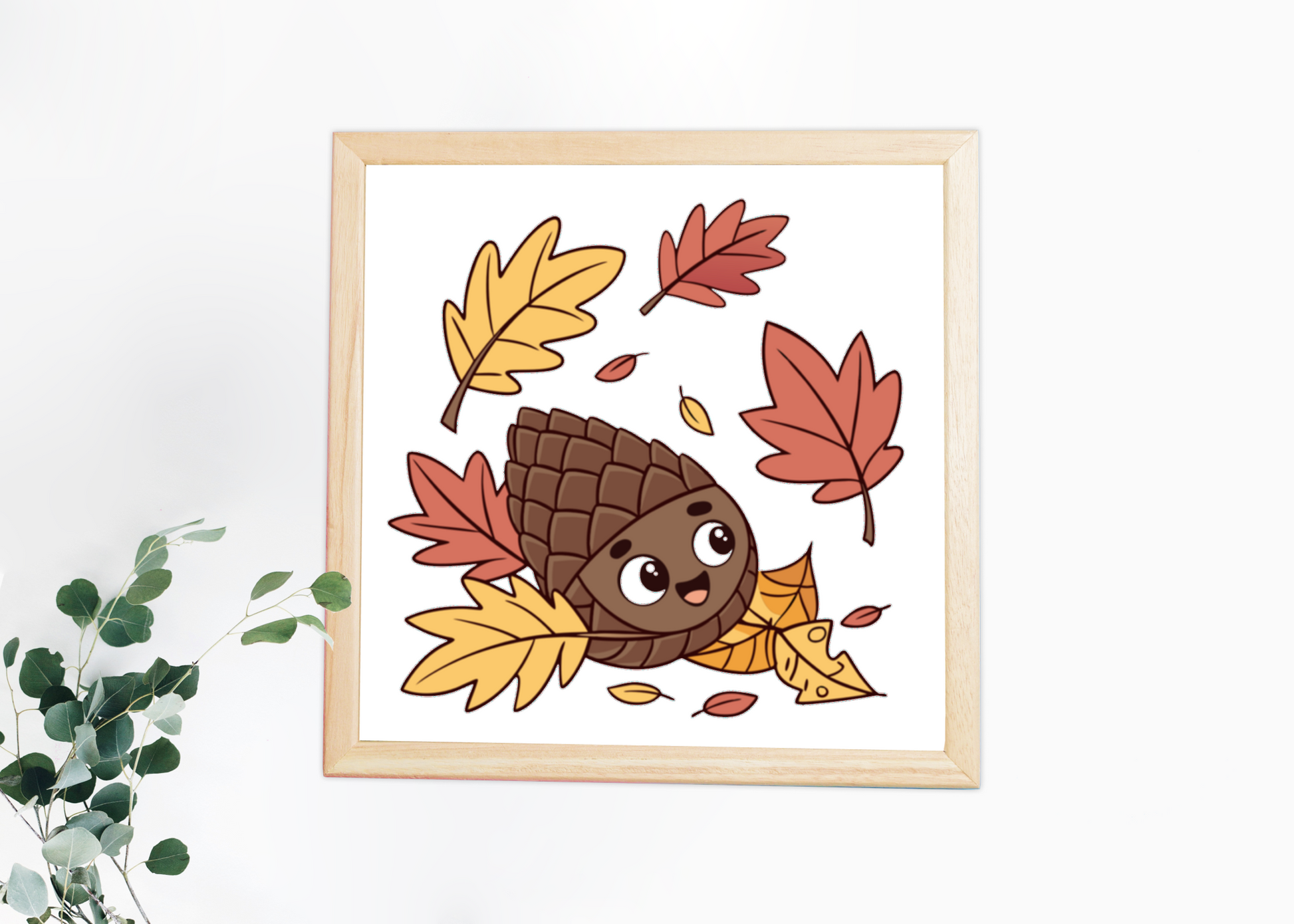 Cadre représentant une pomme de pin joyeuse au cœur de feuilles automnales