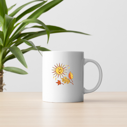 Mug illustré de soleil joyeux entouré de feuilles dorées automnales