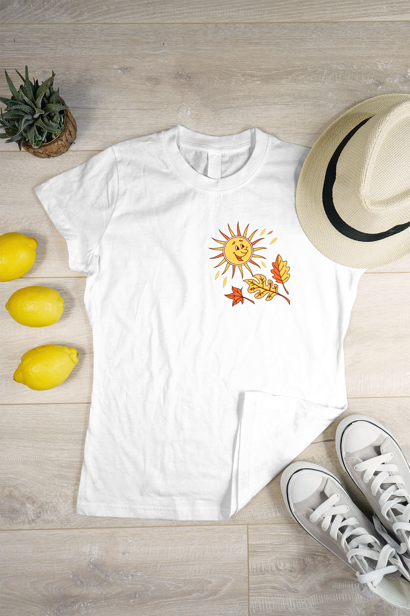 T-shirt avec un soleil souriant et feuilles dorées pour un style automnal joyeux