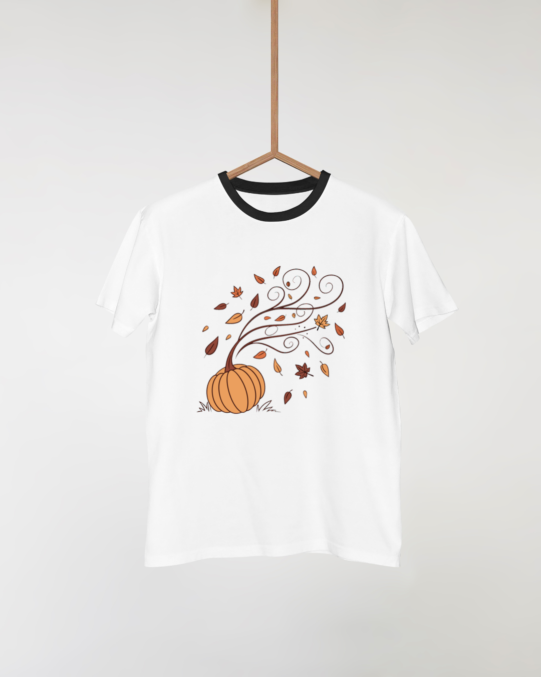 T-shirt automne orné d'une citrouille magique avec feuilles virevoltantes