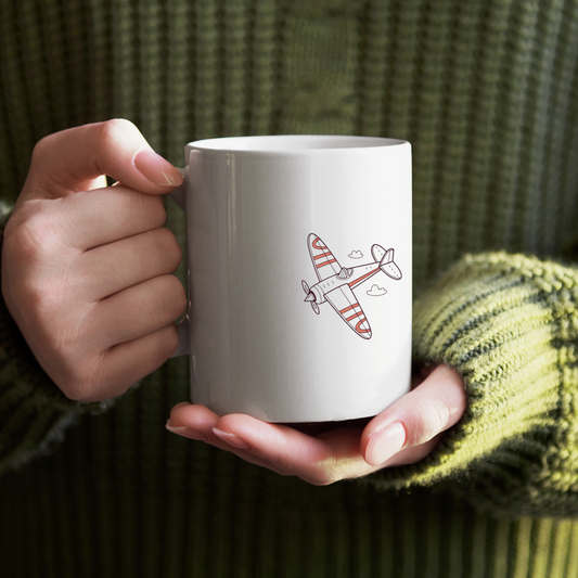 Mug joyeux avec avion multicolore en flat design, ambiance aventure et voyage