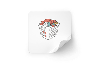Sticker au style minimaliste présentant un panier à linge rempli dans un cadre quotidien