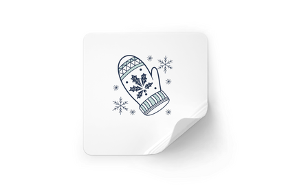 Sticker festif affichant une moufle nordique enneigée sur fond hivernal