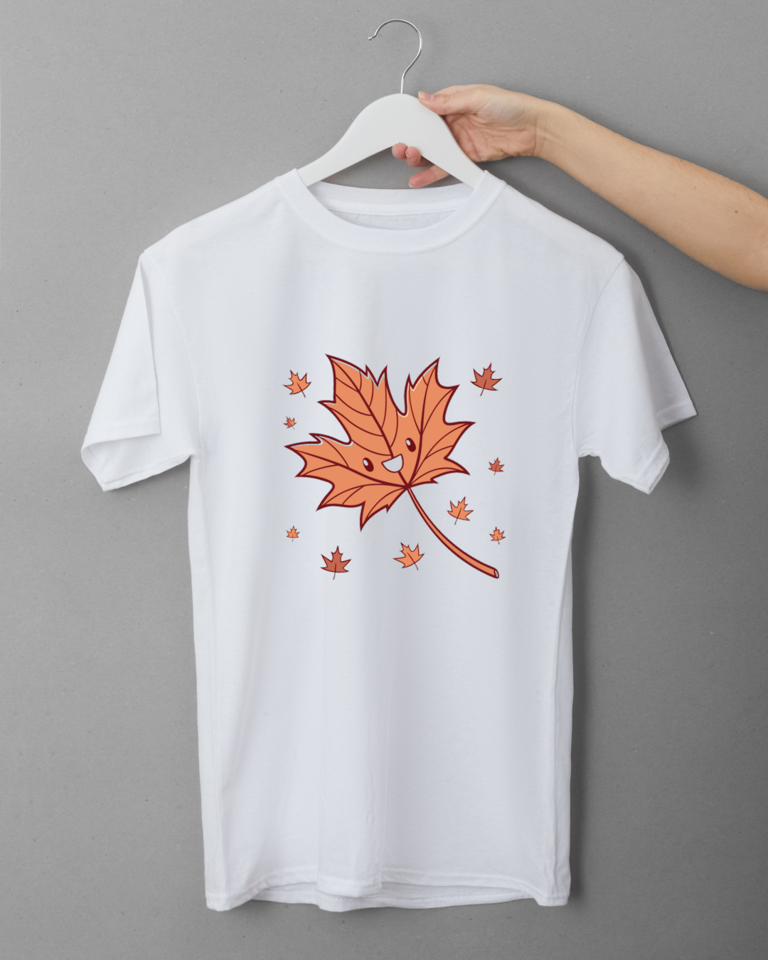 T-shirt avec une feuille d'automne joyeuse en style cartoon, ambiance cosy