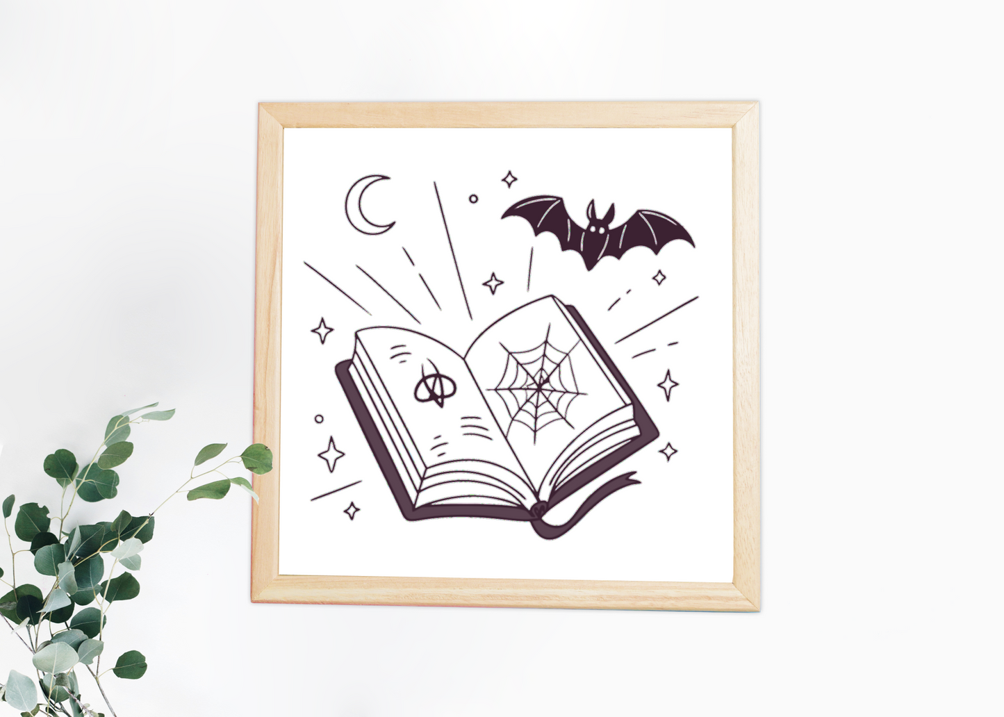 Cadre au style mystique avec livre et chauve-souris pour une touche halloween