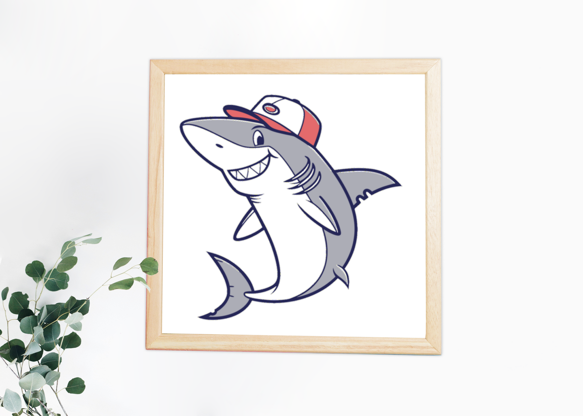 Cadre à thème marin avec un dessin de requin souriant portant une casquette détendue