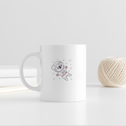 Mug illustré d'un koala joyeux en tenue d'astronaute voyageant dans l'espace