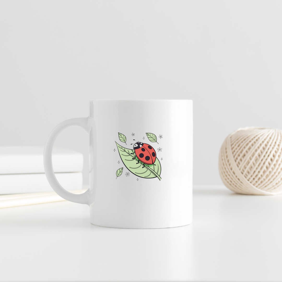 Mug nature affichant une coccinelle souriante sur une feuille verte élégante