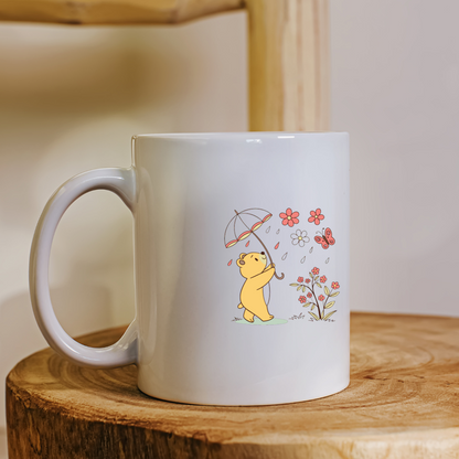 Mug coloré avec ours joyeux sous parapluie ambiance printanière joviale