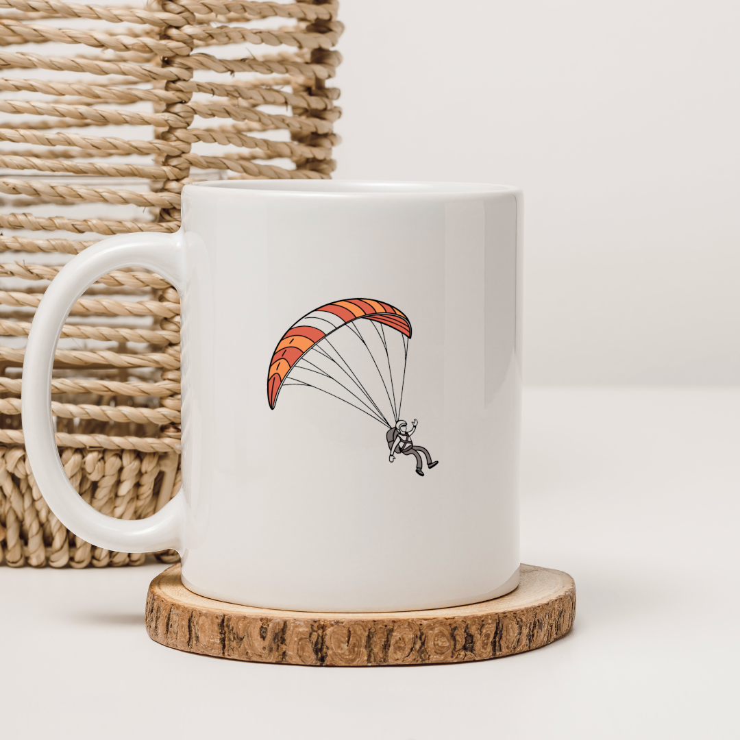 Mug blanc présentant un design dynamique de parapentiste en plein vol